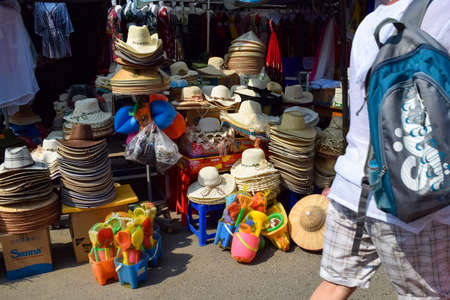 NHA TRANG, VIETNAM - APRIL 19, 2019: Heaps of triangular straw hats in market on street in Asiaのeditorial素材