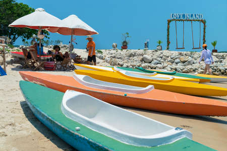 NHA TRANG, VIETNAM - APRIL 19, 2019: olorful boats on beach for tourists in the tropicsのeditorial素材
