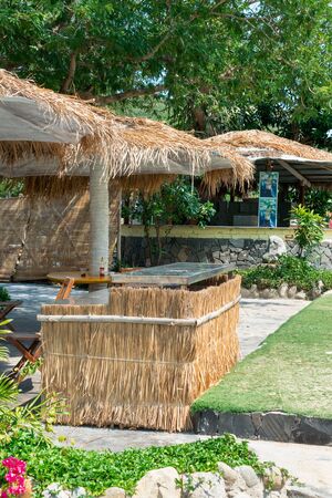 Thatched roof hut in tropics on the beachの写真素材