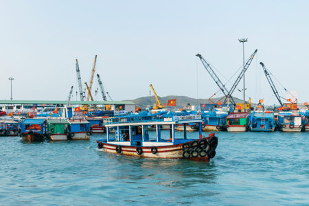 NHA TRANG, VIETNAM - APRIL 19, 2019: Boat in port with old tires on boards at sea in Virtnam