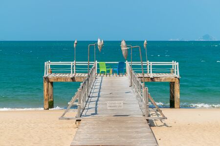 Chairs on wooden platform with wicker lanterns by the seaの写真素材