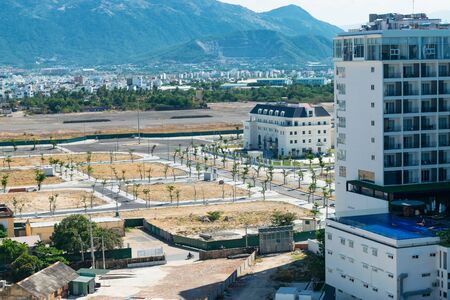 View from the heights to the mountains and empty roads with palm trees and hotelsの写真素材