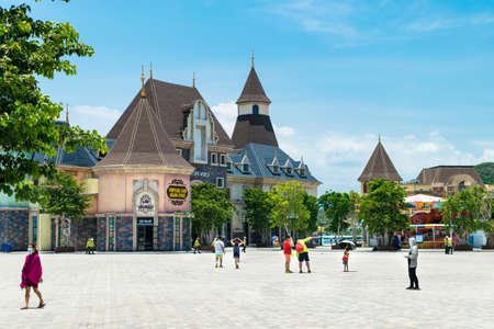 NHA TRANG, VIETNAM - APRIL 16, 2019: Tourists on square in an amusement park with a beautiful building in Vinpearl in Vietnamのeditorial素材