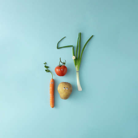 Fresh vegetables with cute eyes on the soft blue background.の写真素材