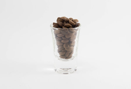 Coffee beans in glass on white backgroundの写真素材