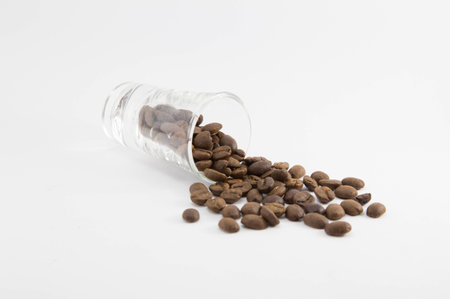 Coffee beans in glass on white backgroundの写真素材