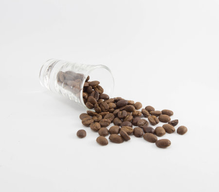 Coffee beans in glass on white backgroundの写真素材