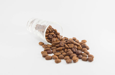 Coffee beans in glass on white backgroundの写真素材