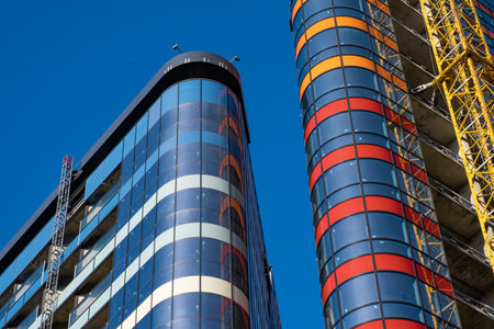 Construction of a modern office building with a blue sky in the backgroundの写真素材