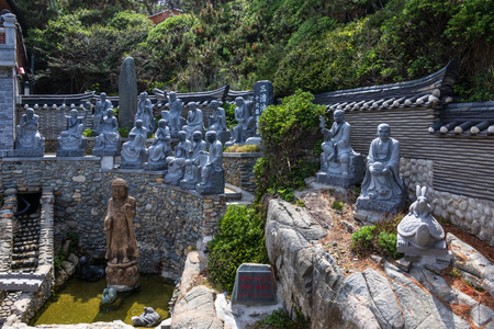 Panoramic view on many religious buddhist statue of praying monks in the korean Haedong Yonggungsa Temple. Busan, South Korea, Asian.の写真素材
