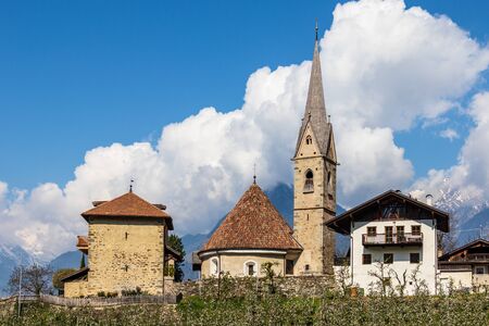 Panorama of Church, Sankt Georgen Kirche and Tower, Uhlenturm in Schenna. Scena, South Tyrol, Italy. Europe.の写真素材