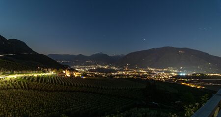 Night Skyline panorama of district Scena vineyards and city Meran valley Burggrafenamt, Meraner Land, Province Bolzano, South Tyrol, Italy. Europe.の写真素材