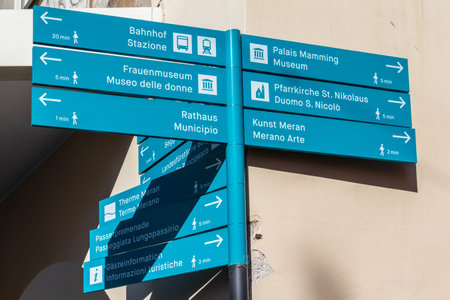 Bilingual Signpost in the main district of Meran guide tourists located in Laubengasse. Merano....
