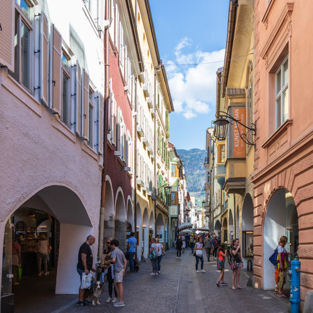 Street scenario of Laubengasse in the main District of Meran with many pedestrians. Merano. Province...
