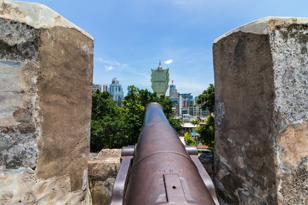 Replica cannon and defense wall of Mount Fortress, Fortaleza do Monte, Skyline of Macau in background. Santo AntÃ³nio, Macao, China. Asia.のeditorial素材