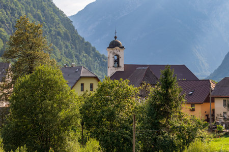 Panorama with buildings, and Parish Church inside Mountain Landscape of Village Log pod Mangartom....