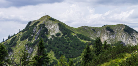 Panorama of Mount Hoher Ziegspitz, 1864 m with Summit Cross in Ammergauer Alps, in...