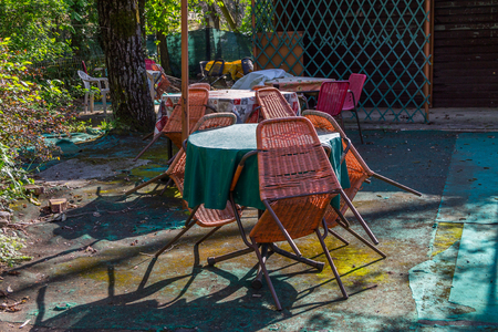 Abandoned cafe, old table and swing, abandoned house where no one has ever been, crisis, ruinの写真素材