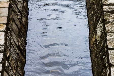 A water channel, a small river flows through a technical channelの写真素材