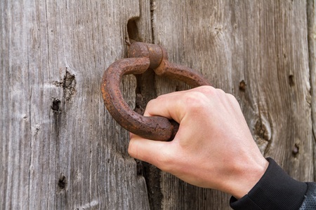 An ancient handmade door bell, A knock at the door, a wooden doorの写真素材