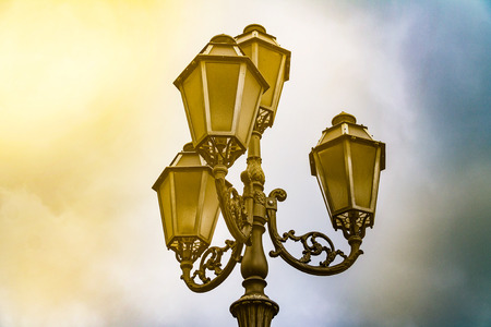 Ancient street lamp on the sky backgroundの写真素材