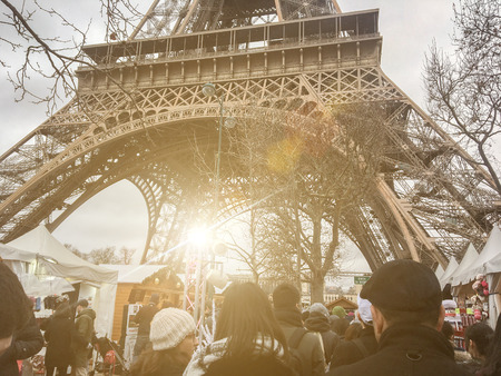 France, Paris, 24 December. Celebrating Christmas near the Eiffel Tower, tourists at the fair in Parisのeditorial素材
