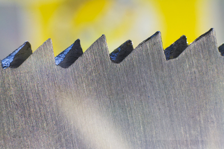 Circular saw cutting wooden plank. Blade with board close-up. Woodworking detail with wood. Working equipment carpentry workshop.の写真素材