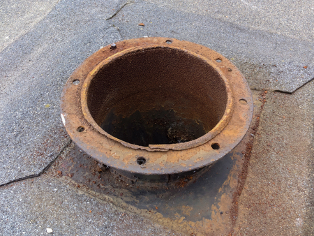 part of the brown rusty iron pipe ventilation on the wall of the buildingの写真素材