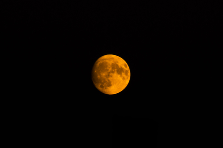 yellow moon in the dark blue background of the night skyの写真素材