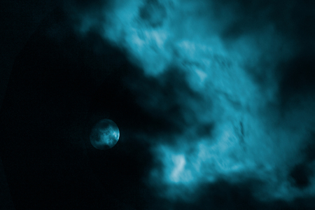 moon under a dark cloud, night sky, backgroundの写真素材