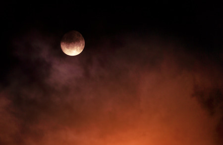 moon under a dark cloud, night sky, backgroundの写真素材