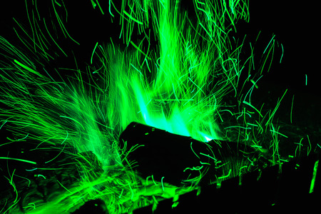Burning firewood in the fireplace, coal background. Coal fire with sparksの写真素材