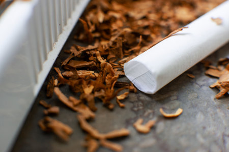 homemade cigarettes and tobacco, close-up with copy space. Cigarette productionの写真素材