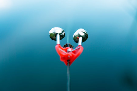 Fishing bell hanging on a fishing lineの写真素材