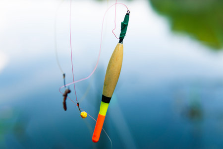 Float and fishing hooks with bait hanging on a fishing line