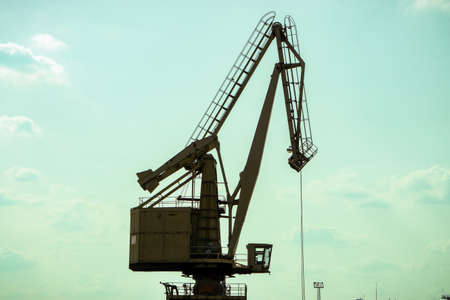 Crane in the seaport for coal loading. Crane moves along railsの写真素材