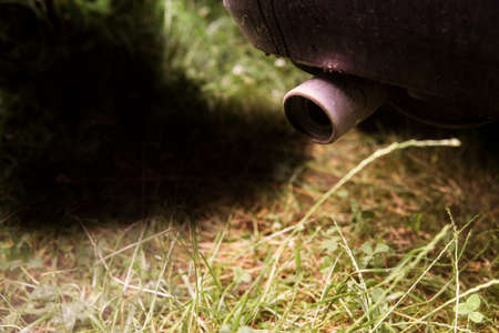 Exhaust gases from the muffler of the car. Close-up. Black smoke. The concept of harm to the environment from internal combustion enginesの写真素材