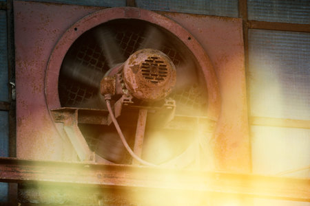 Iron fan with motor mounted in the wall of the houseの写真素材