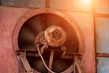 Iron fan with motor mounted in the wall of the houseの写真素材