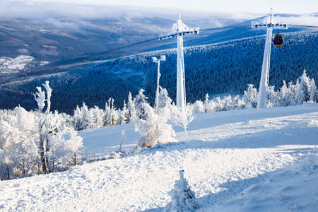 Funicular in the snowy mountains. Gondola. Holidays in the mountains. Snow-covered Christmas trees. Sports recreationの写真素材