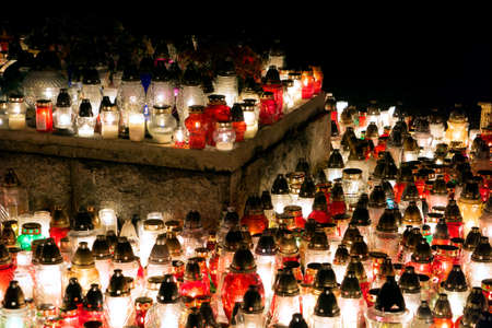 Burning candles at a cemetery during All Saints Day.の写真素材