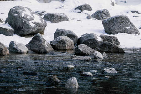 Stone on ice. Winter landscape. Cold water in the lakeの写真素材