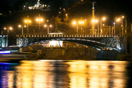 A bridge in the center of Prague illuminated by bright lightsの写真素材