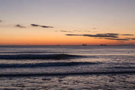 blue sea and clouds in the sky, sunrise on the horizonの写真素材