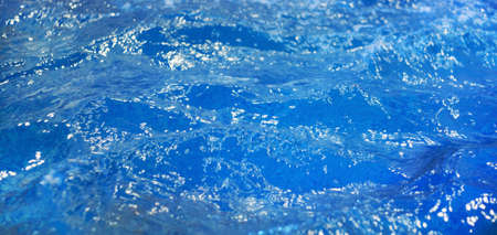 Abstract background blue water in the pool, lots of bubbles in the waterの写真素材