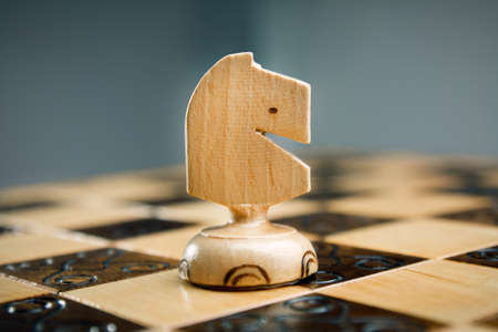 Wooden chess, white horse on a chessboardの写真素材