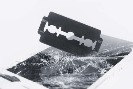 Broken phone screen, blade cuts smartphone screenの写真素材