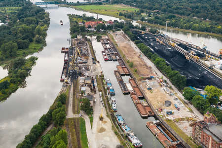 Many rivers merge into one. Anchorage for barges carrying coal, Poland Wroclawの写真素材