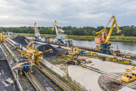 Unloading coal at a power plant, many cranesの写真素材