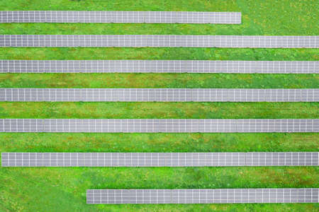 Solar farm on the field, many solar panels in a row. Alternative power sourceの写真素材